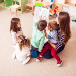 beautiful-young-teacher-showing-explaining-figures-preschoolers-children-sit-circle-2